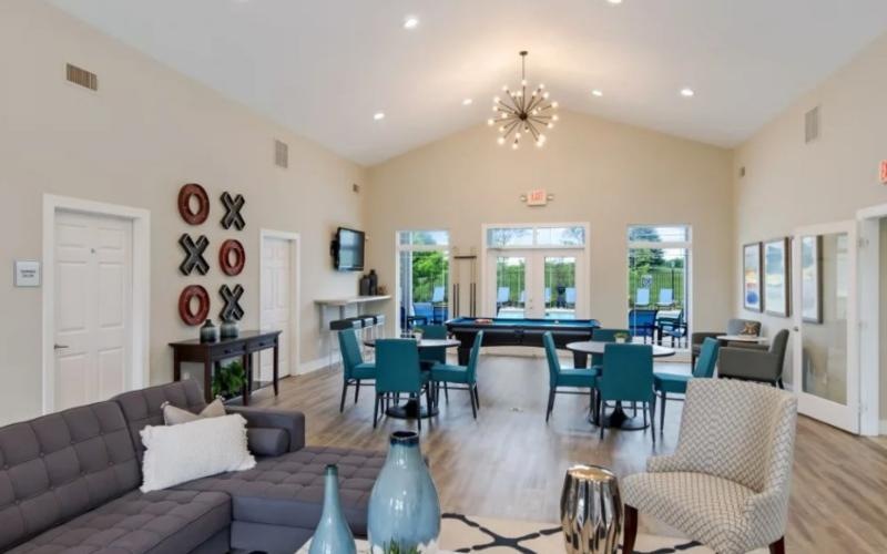 a living room with a couch and chairs
